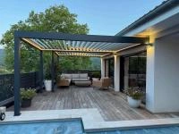 Pergola Alusun Aluclos en aluminium RAL 7016 avec bandeau LED modèle bioclimatique avec lames parallèles à la façade.